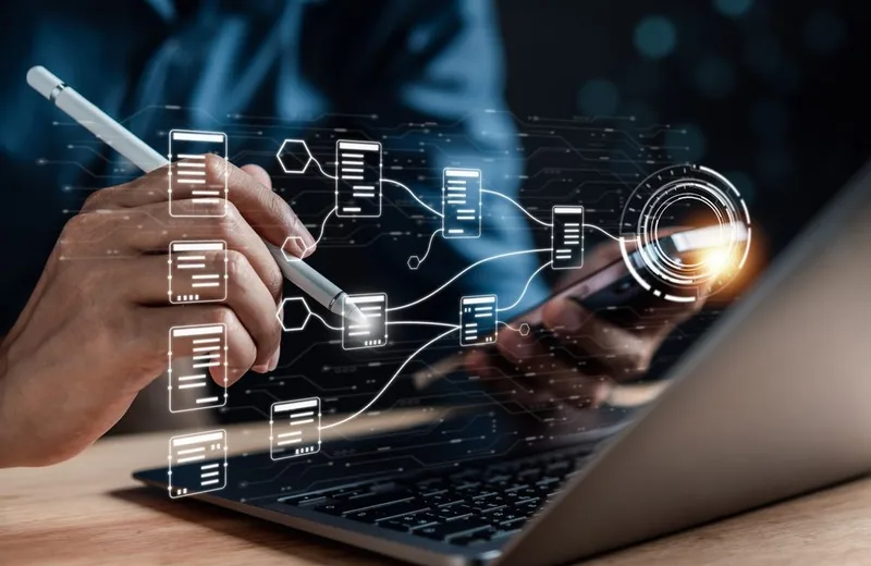 IT professional working in a server room with AI-driven monitoring displays